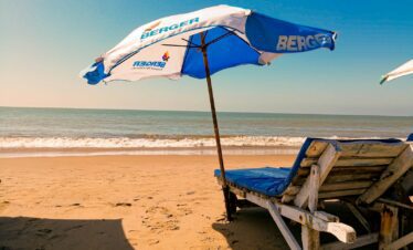 brown wooden chair on beach during daytime