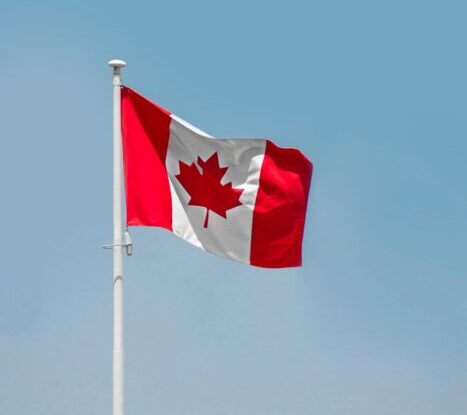 a red and white flag on a flagpole